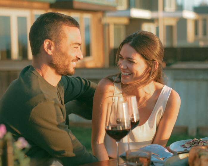 Lyric Wine couple with wine glasses looking at eachother